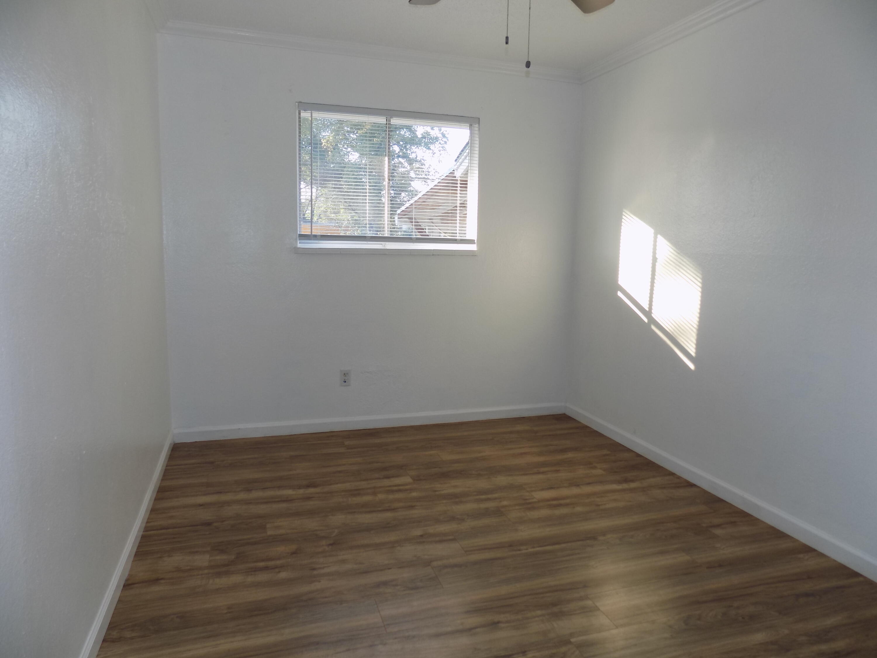 7658 Happy Valley Road Anderson, CA 96007 - Photo 15 of 25 an empty room with wooden floor and windows