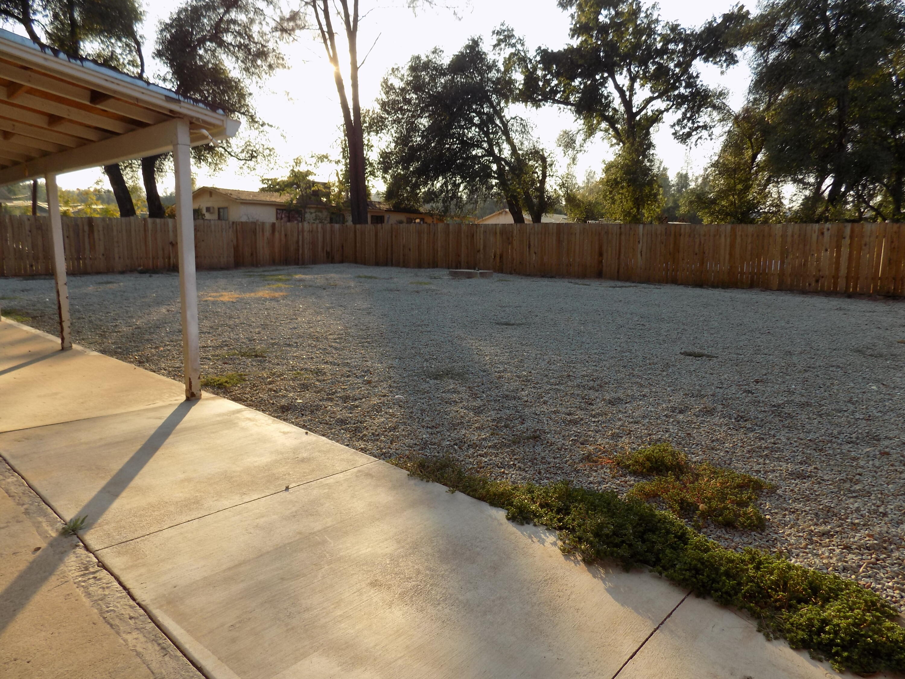 7658 Happy Valley Road Anderson, CA 96007 - Photo 19 of 25 a backyard of a house with lots of green space