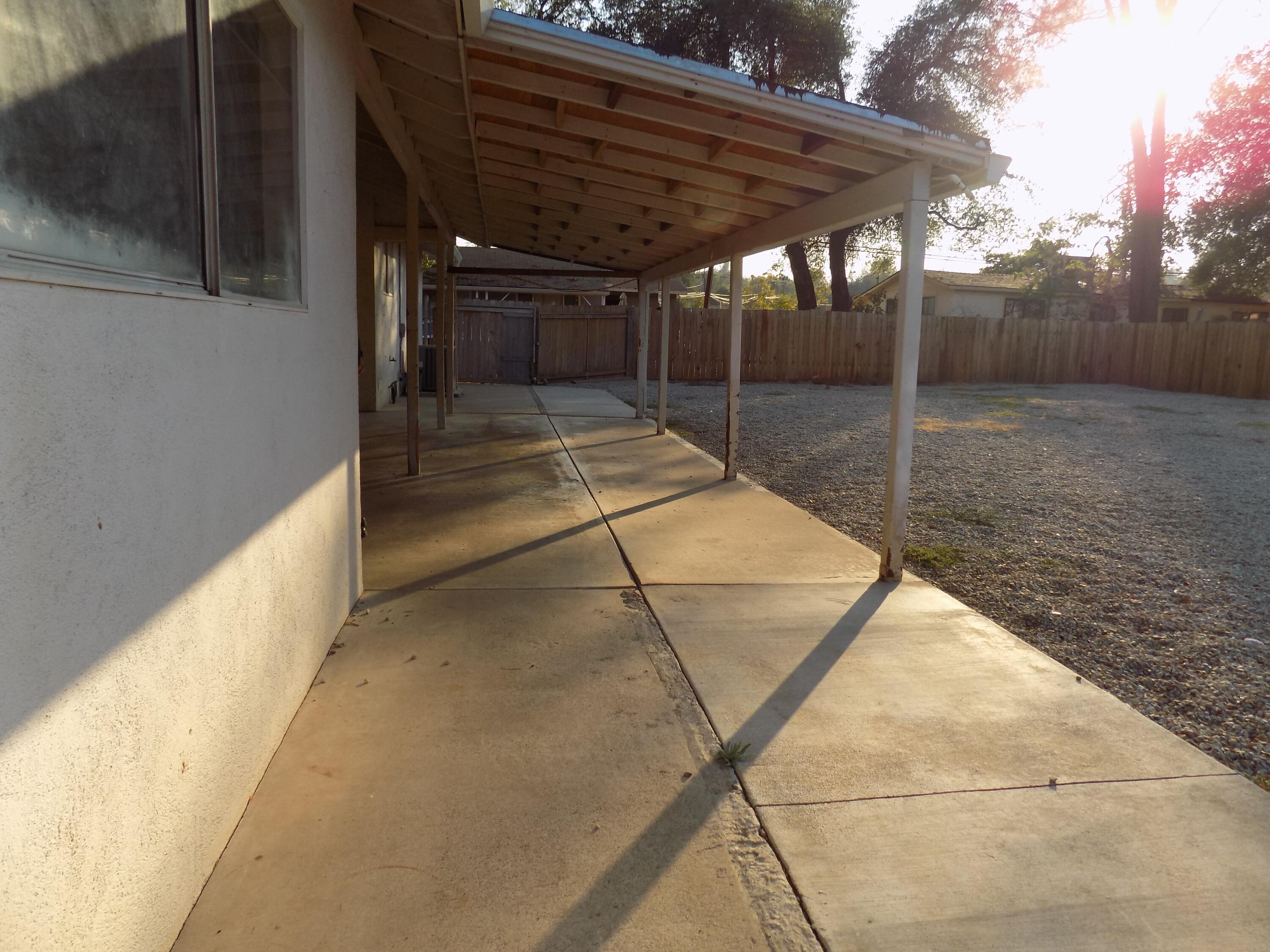 7658 Happy Valley Road Anderson, CA 96007 - Photo 20 of 25 a backyard of a house with basket ball court and wooden floor