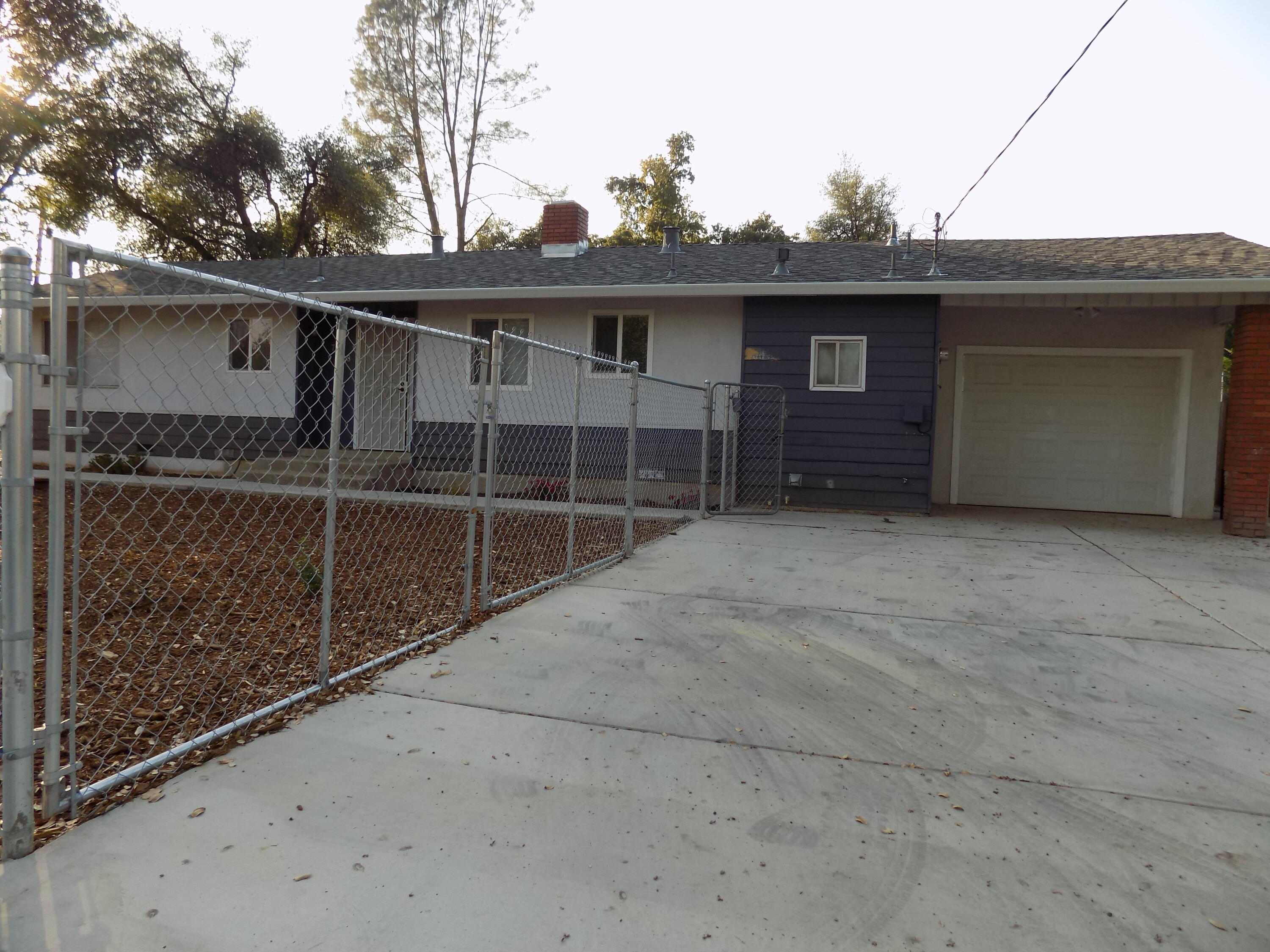7658 Happy Valley Road Anderson, CA 96007 - Photo 3 of 25 a front view of a house with garage