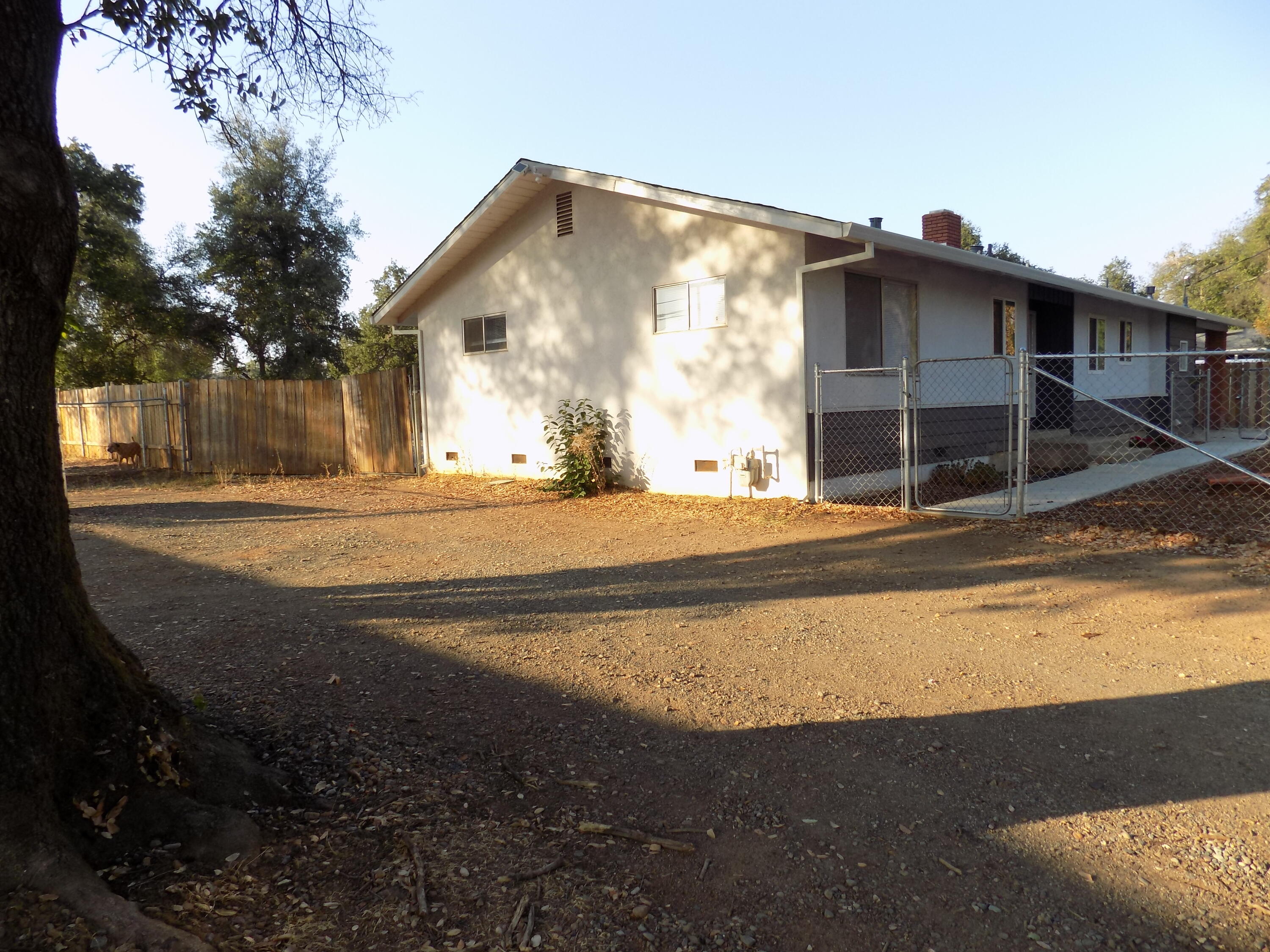 7658 Happy Valley Road Anderson, CA 96007 - Photo 5 of 25 a view of a house with backyard and trees