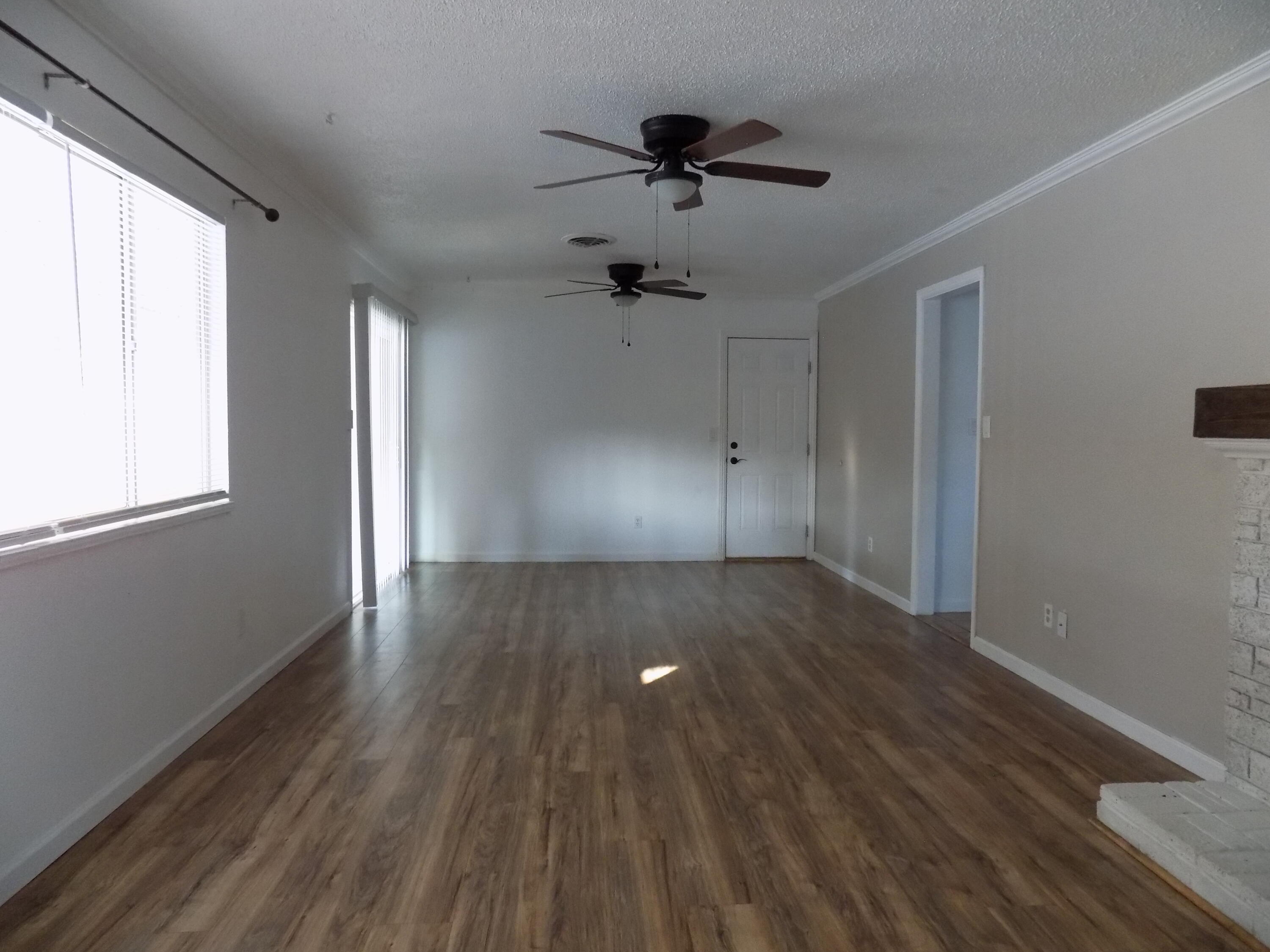 7658 Happy Valley Road Anderson, CA 96007 - Photo 6 of 25 a view of empty room with wooden floor and fan