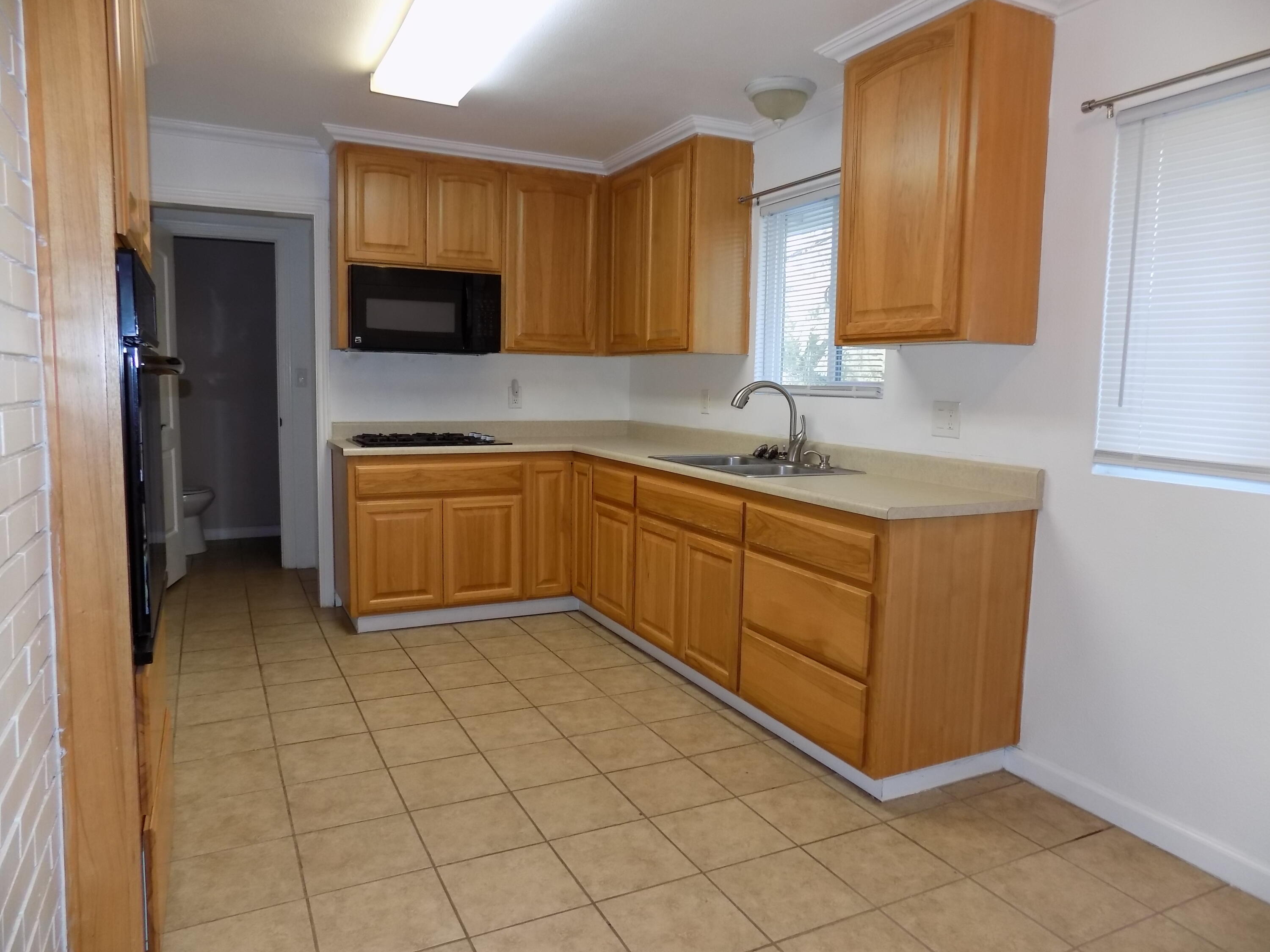 7658 Happy Valley Road Anderson, CA 96007 - Photo 8 of 25 a kitchen with stainless steel appliances a sink cabinets and microwave