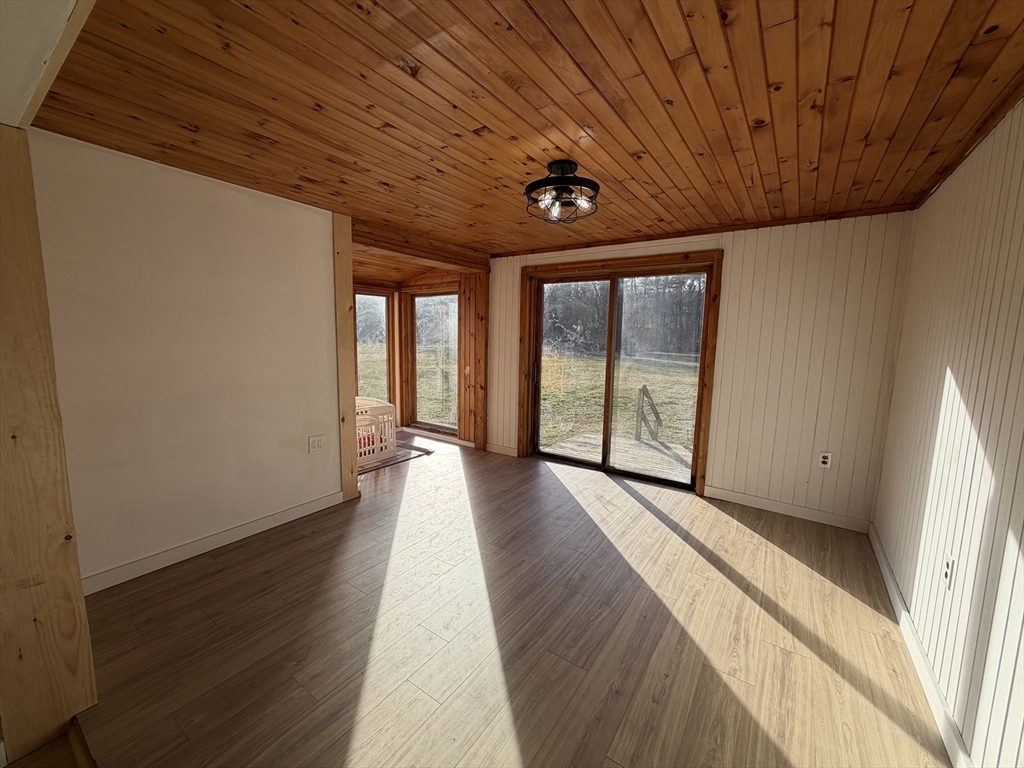 336 Plain Road Greenfield, MA 01301 - Photo 15 of 30 a view of a hall with wooden floor and windows