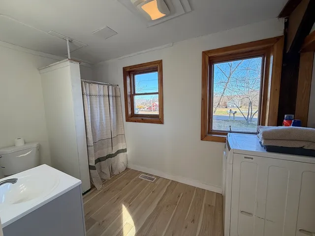 a kitchen with a wooden floor and a window