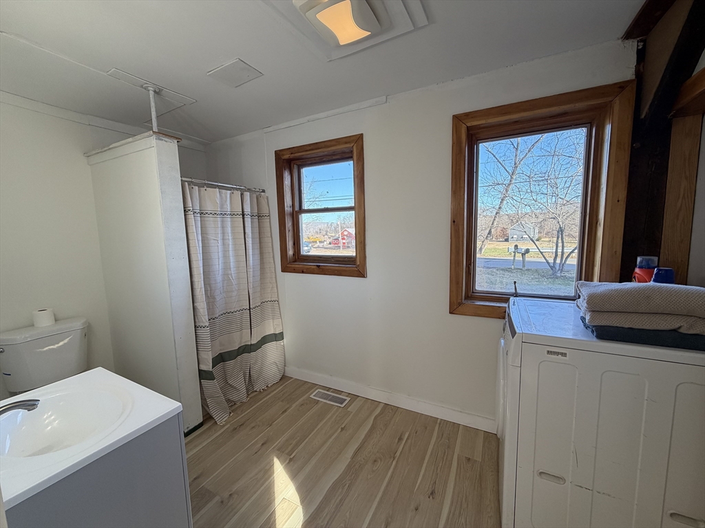 336 Plain Road Greenfield, MA 01301 - Photo 17 of 30 a kitchen with a wooden floor and a window