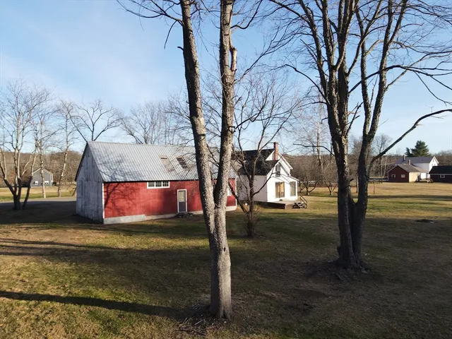a view of an house with backyard space and balcony