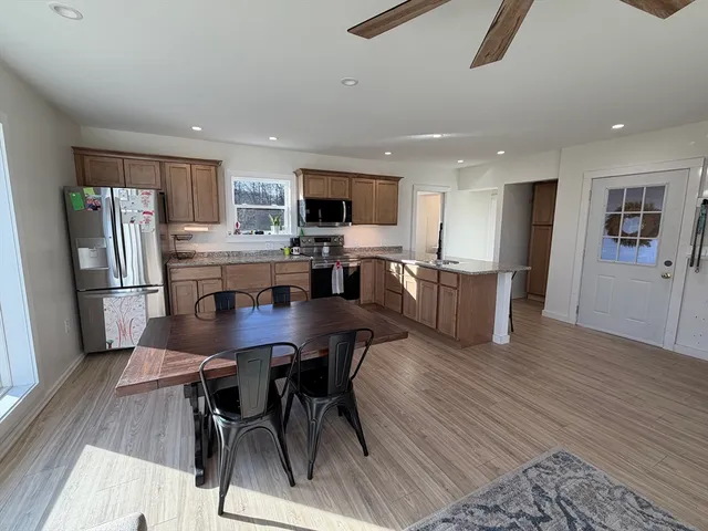 a view of kitchen with refrigerator microwave and wooden floor