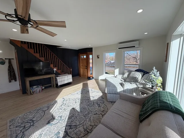 a living room with furniture gym equipment and a view of bedroom