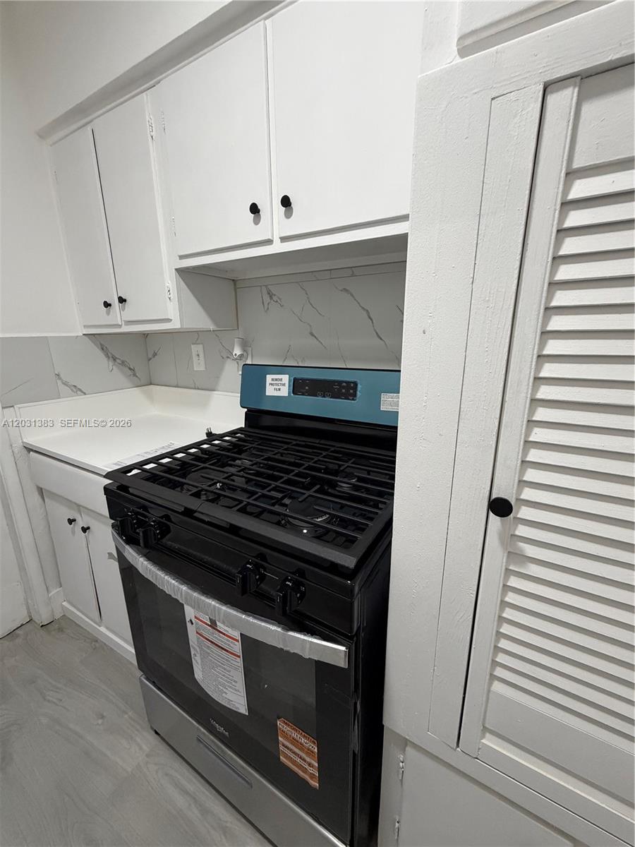 324 Surfside Boulevard, Unit 7 Surfside, FL 33154 - Photo 4 of 8 a stove top oven sitting inside of a kitchen
