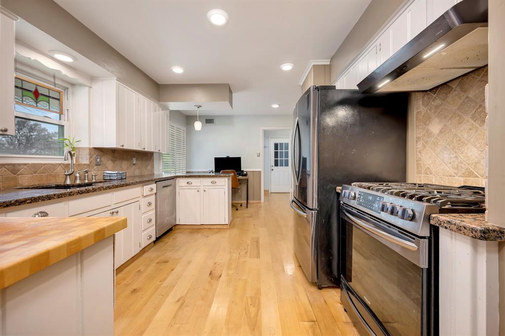 10005 Ridgehaven Drive Dallas, TX 75238 - Photo 11 of 27 a kitchen with stainless steel appliances granite countertop a stove a sink and a refrigerator