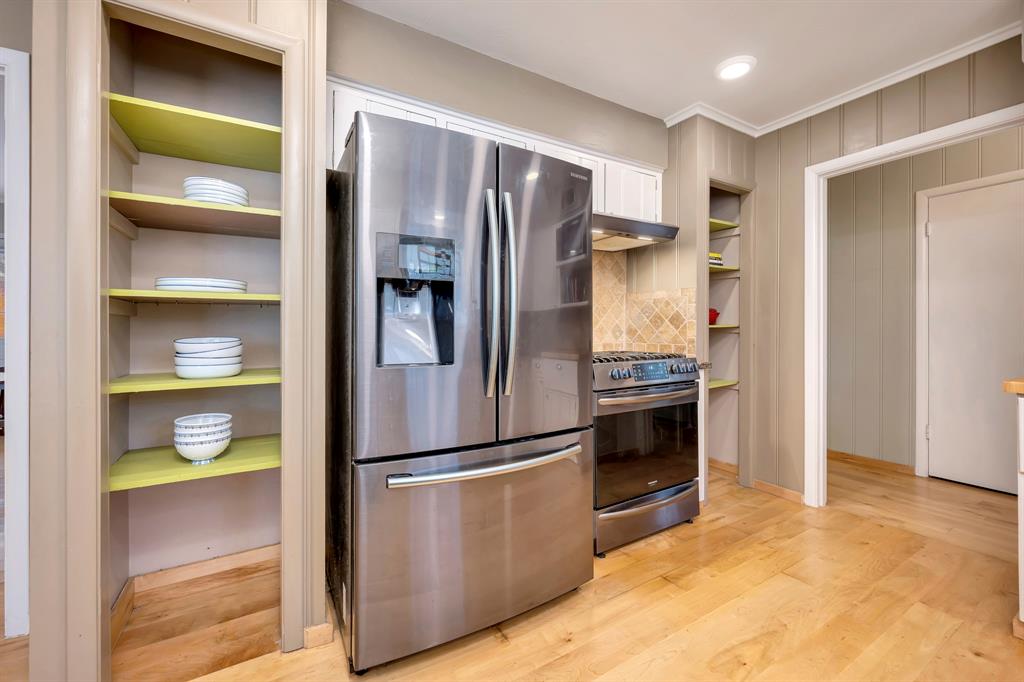 10005 Ridgehaven Drive Dallas, TX 75238 - Photo 13 of 27 a kitchen with a refrigerator and a stove