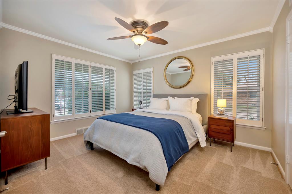 10005 Ridgehaven Drive Dallas, TX 75238 - Photo 15 of 27 a bedroom with a bed mirror and a large window