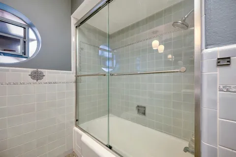 a bathroom with a bathtub and a shower