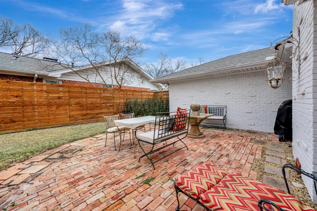 10005 Ridgehaven Drive Dallas, TX 75238 - Photo 22 of 27 a view of a patio with table and chairs and potted plants