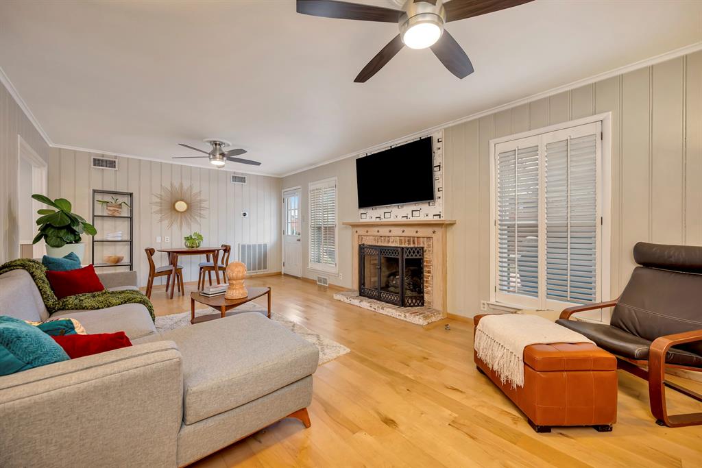 10005 Ridgehaven Drive Dallas, TX 75238 - Photo 4 of 27 a living room with furniture a fireplace and a flat screen tv