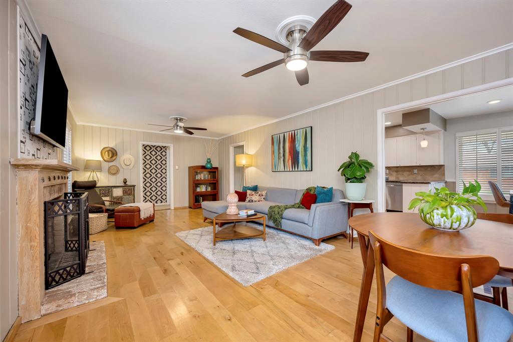 10005 Ridgehaven Drive Dallas, TX 75238 - Photo 6 of 27 a living room with fireplace furniture and a flat screen tv