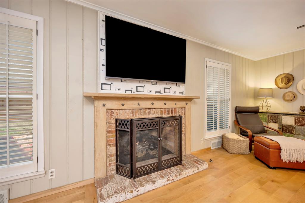 10005 Ridgehaven Drive Dallas, TX 75238 - Photo 8 of 27 a living room with furniture a flat screen tv and a fireplace