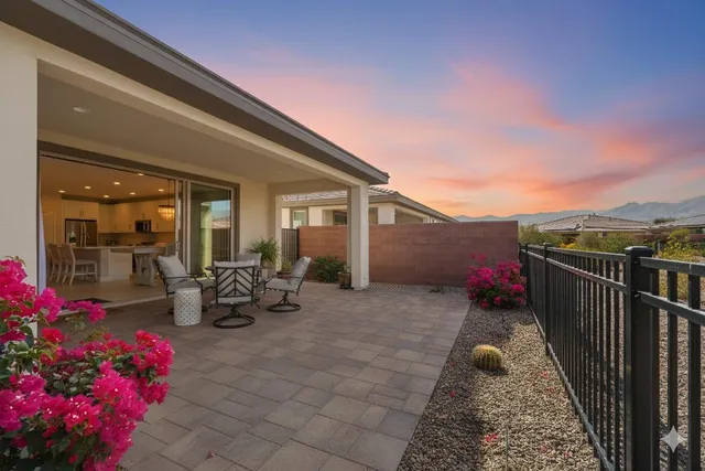a group of people sitting in front of a house