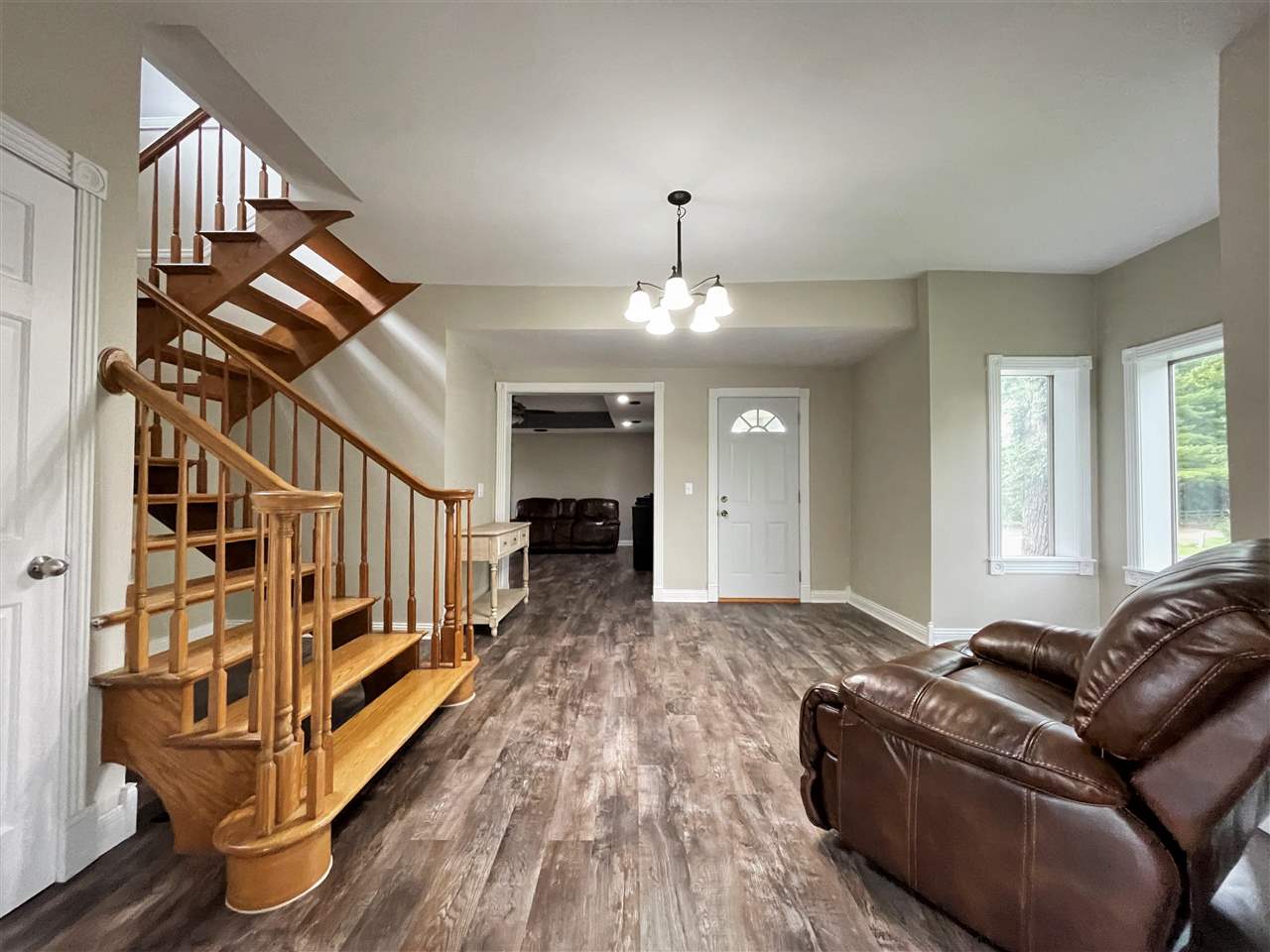 7545 Kishwaukee Road Stillman Valley, IL 61084 - Photo 17 of 61 a living room with furniture or wooden floor and a chandelier