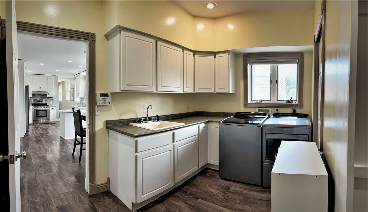 7545 Kishwaukee Road Stillman Valley, IL 61084 - Photo 31 of 61 a kitchen with kitchen island granite countertop a sink cabinets and stainless steel appliances
