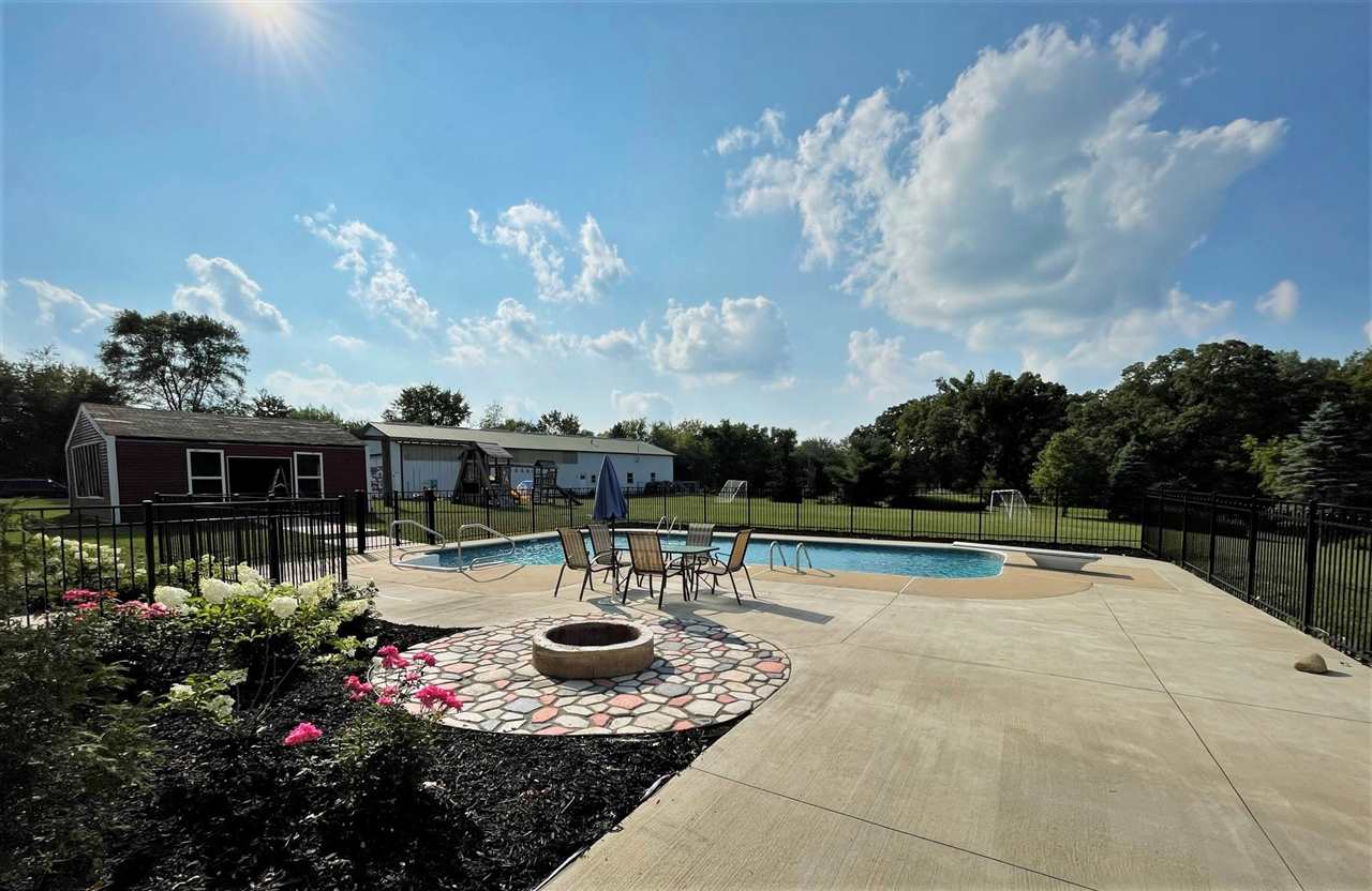 7545 Kishwaukee Road Stillman Valley, IL 61084 - Photo 46 of 61 a view of a swimming pool with a patio