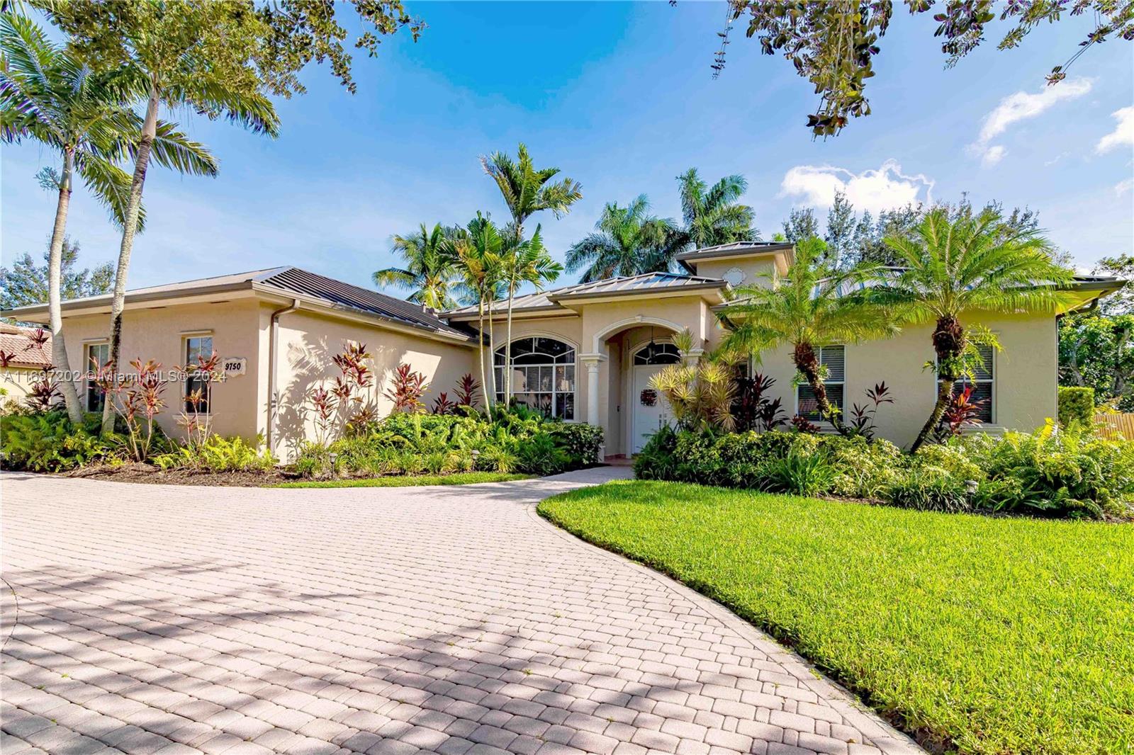 9750 Southwest 143rd Street Miami, FL 33176 - Photo 1 of 41 a front view of a house with a yard and potted plants
