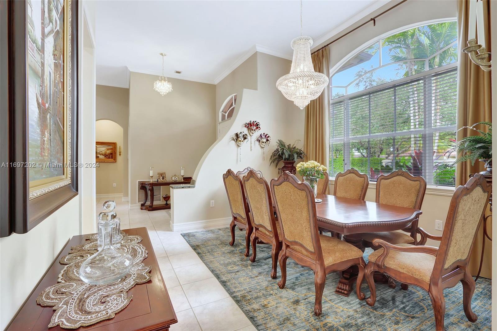 9750 Southwest 143rd Street Miami, FL 33176 - Photo 13 of 41 a view of a dining room with furniture wooden floor and a chandelier