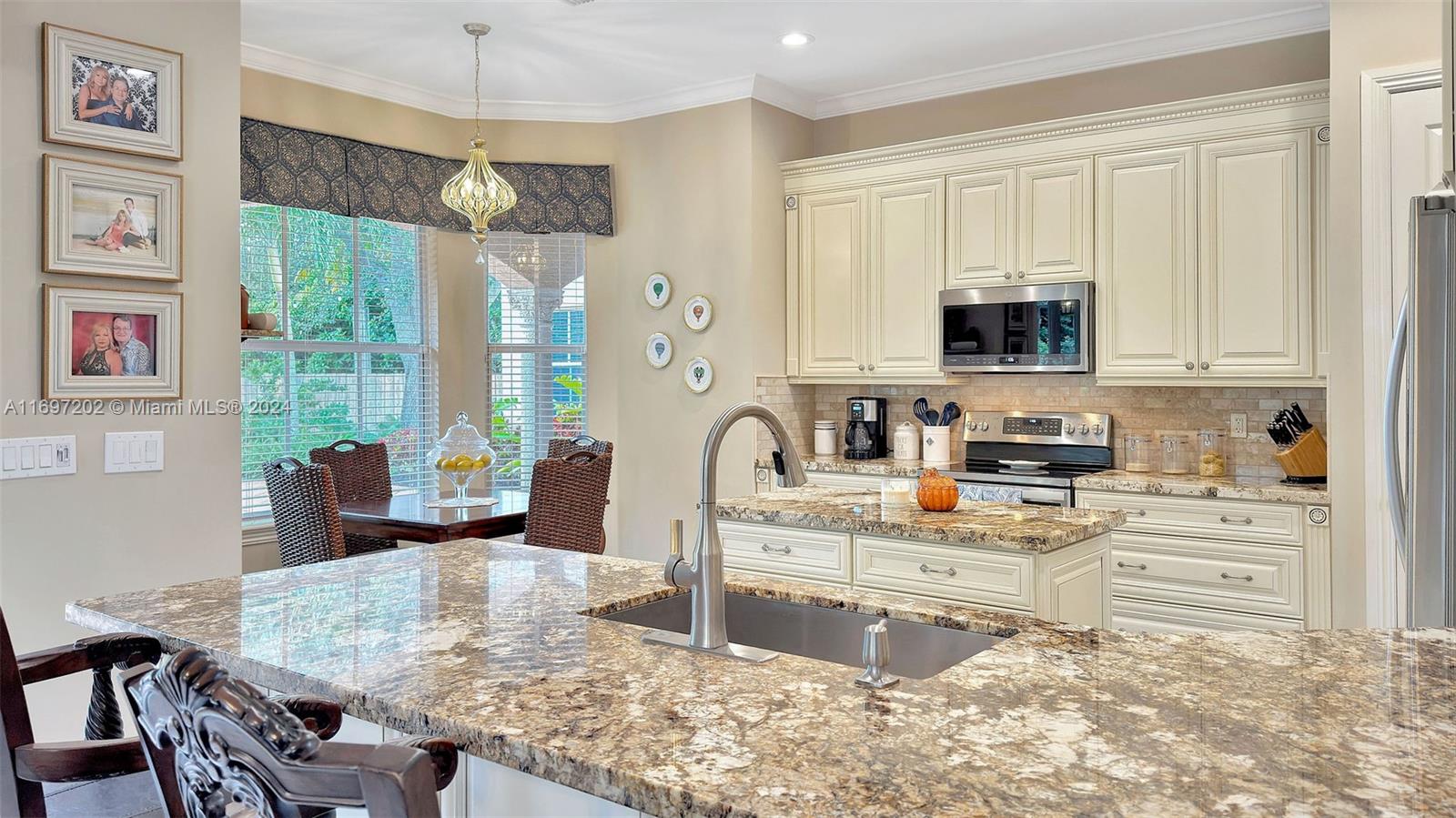 9750 Southwest 143rd Street Miami, FL 33176 - Photo 16 of 41 a kitchen with stainless steel appliances granite countertop a stove top oven a sink dishwasher and cabinets with wooden floor