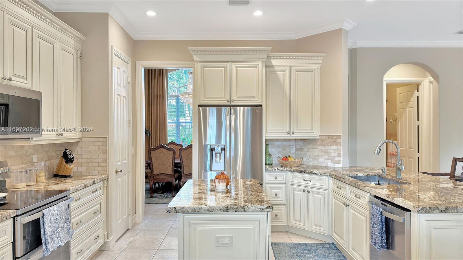 9750 Southwest 143rd Street Miami, FL 33176 - Photo 19 of 41 a kitchen with stainless steel appliances granite countertop a stove a sink and a refrigerator