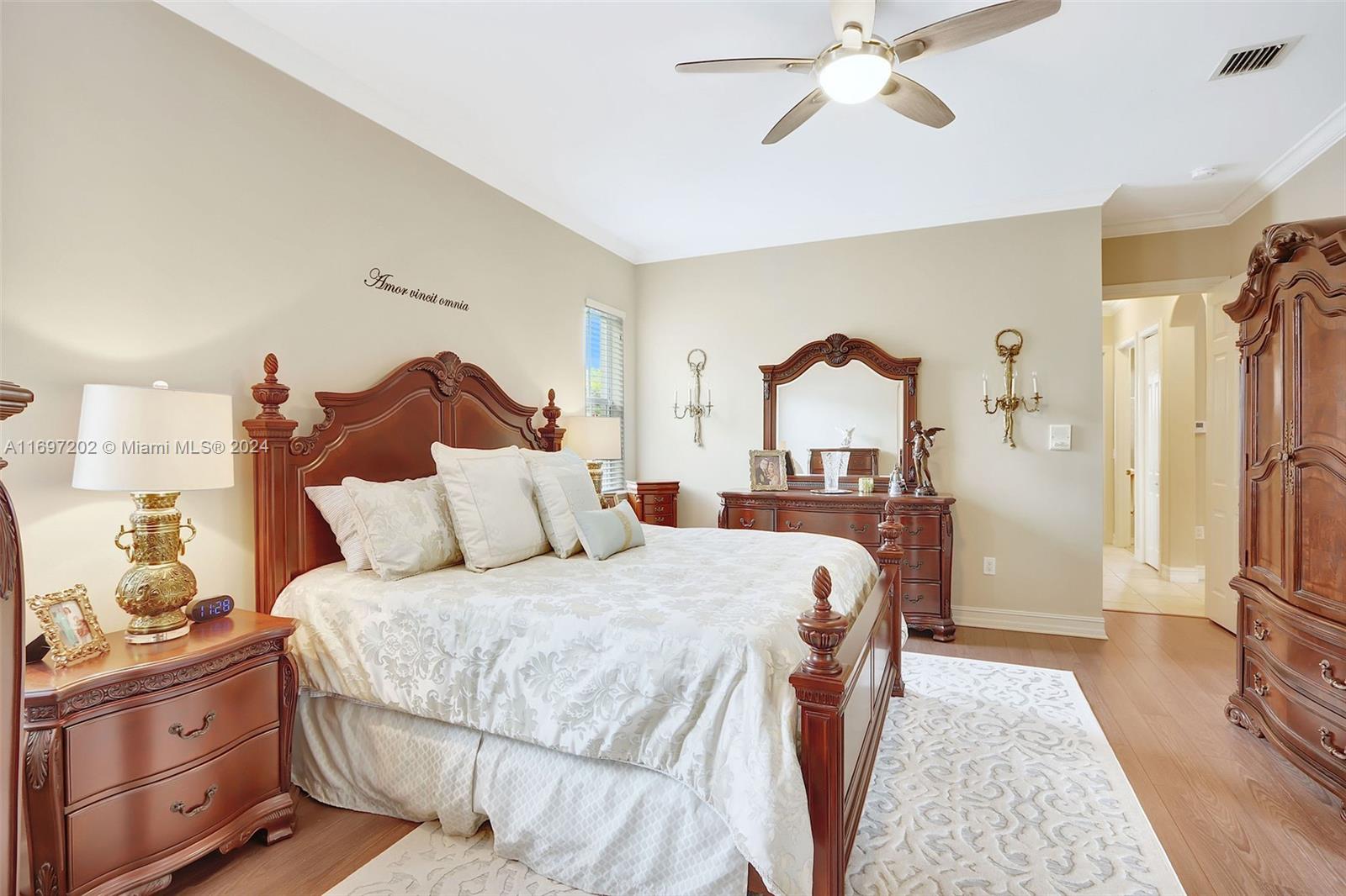 9750 Southwest 143rd Street Miami, FL 33176 - Photo 24 of 41 a bedroom with a bed and a chandelier