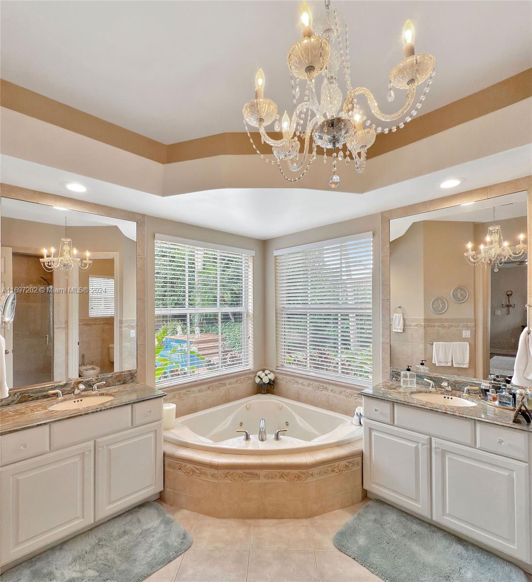 9750 Southwest 143rd Street Miami, FL 33176 - Photo 26 of 41 a spacious bathroom with a granite countertop tub a sink and a large window