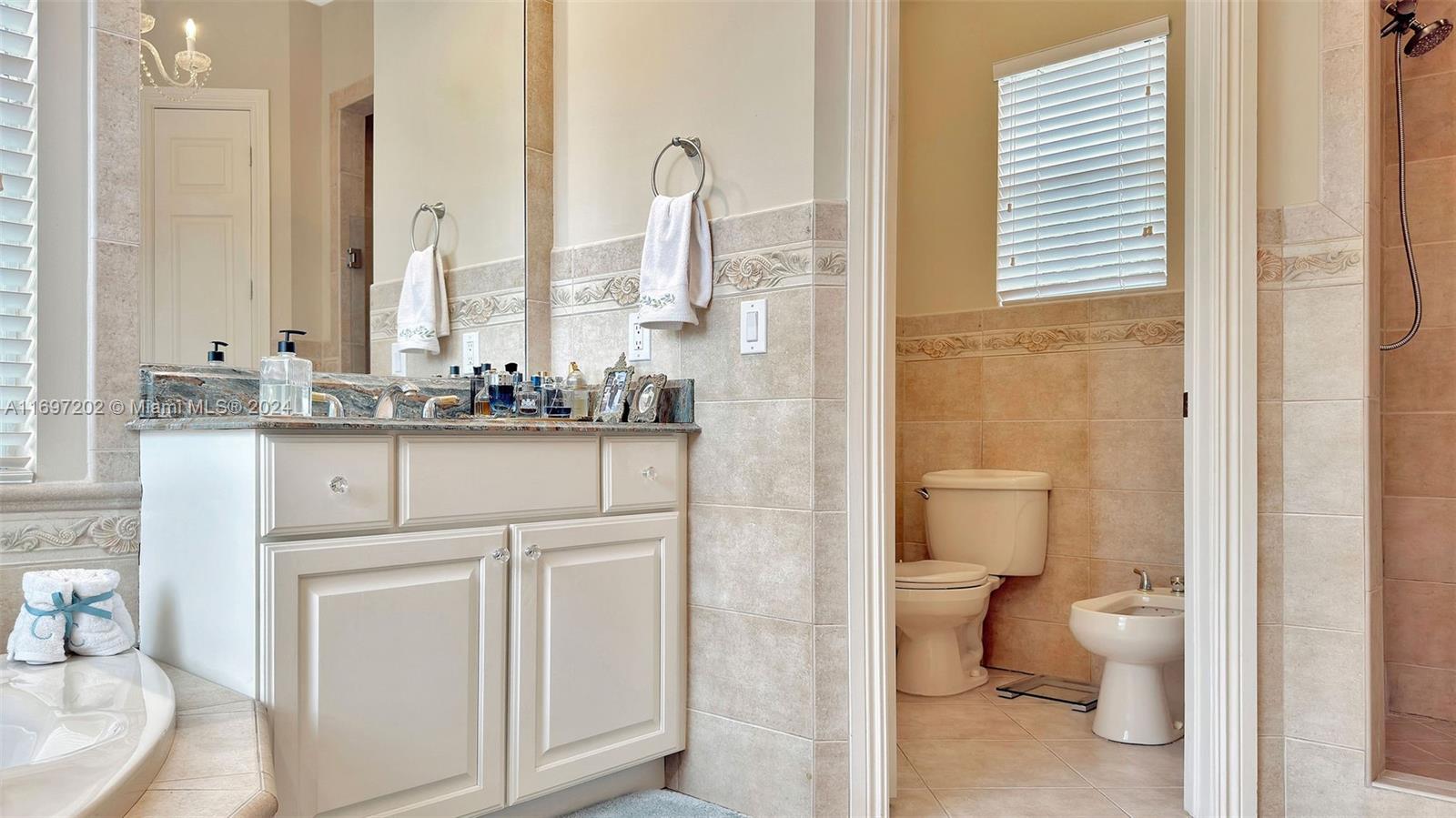 9750 Southwest 143rd Street Miami, FL 33176 - Photo 27 of 41 a bathroom with a sink a toilet and a mirror