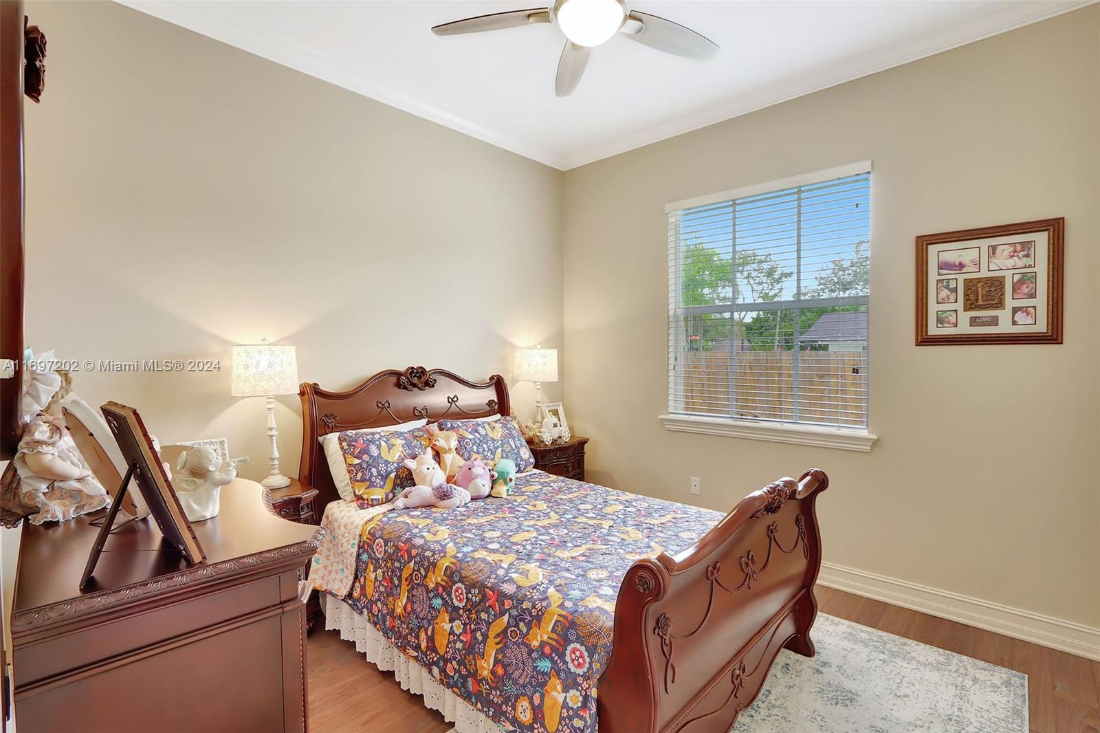 9750 Southwest 143rd Street Miami, FL 33176 - Photo 30 of 41 a bedroom with a bed and a window