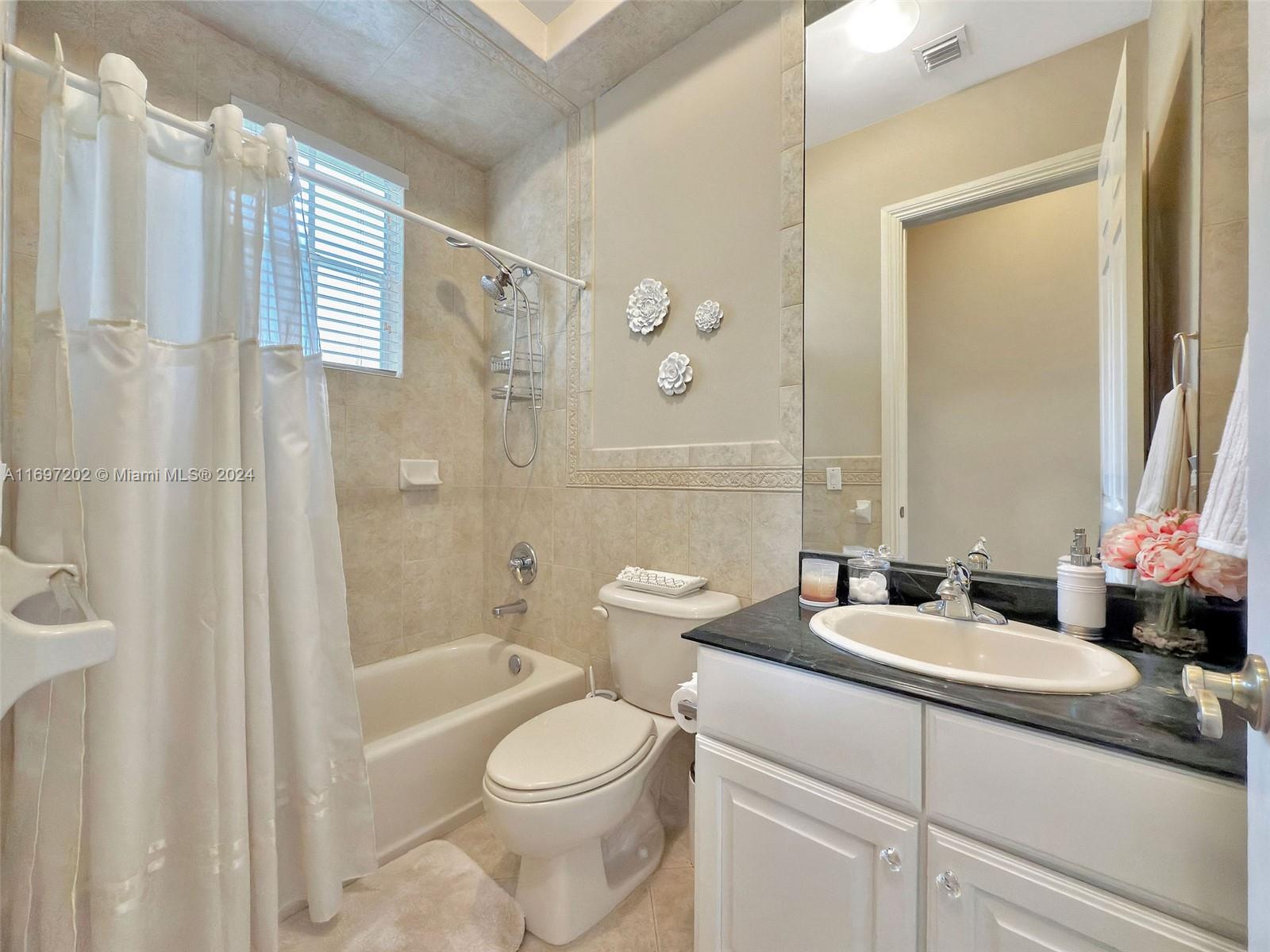 9750 Southwest 143rd Street Miami, FL 33176 - Photo 32 of 41 a bathroom with a sink a toilet and shower