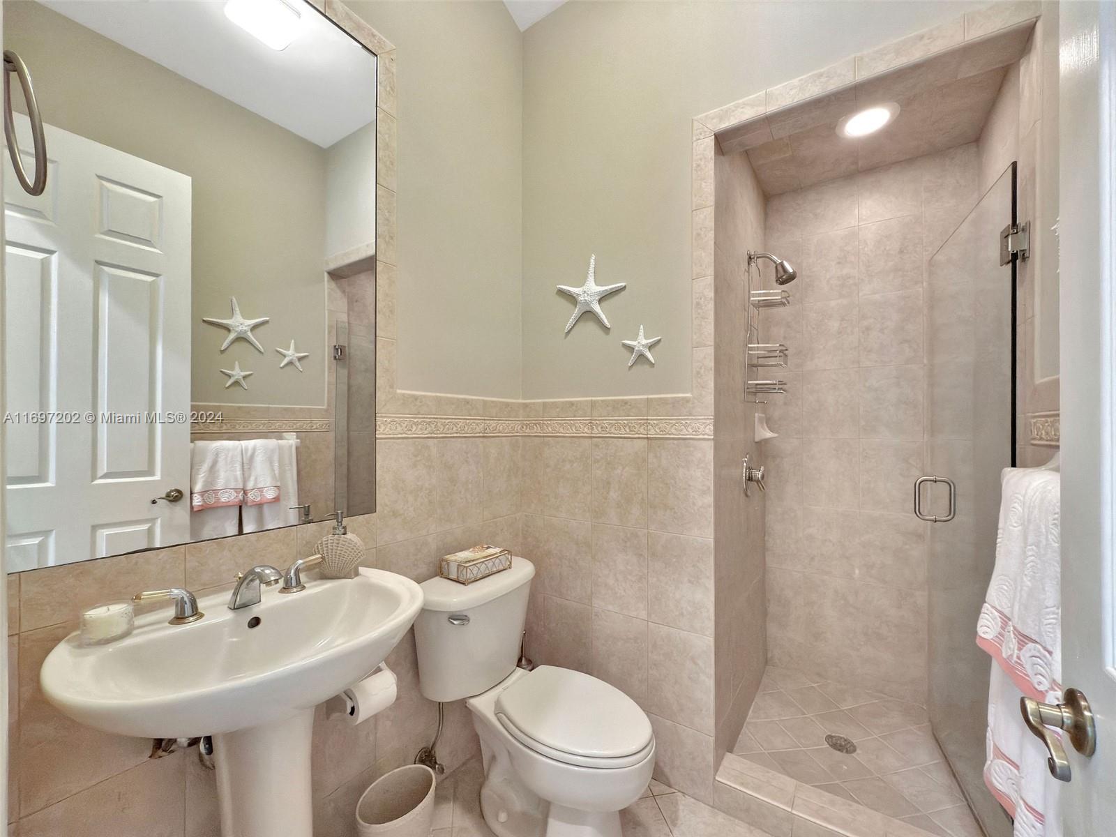 9750 Southwest 143rd Street Miami, FL 33176 - Photo 34 of 41 a bathroom with a sink toilet and shower