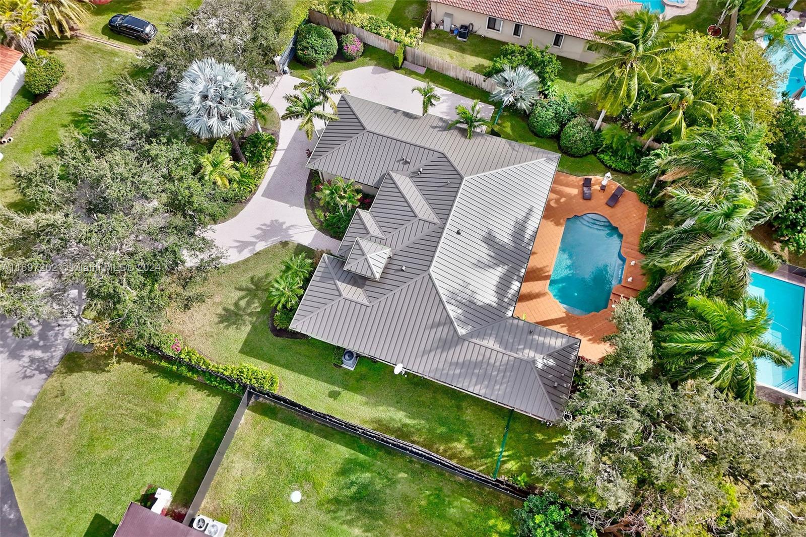 9750 Southwest 143rd Street Miami, FL 33176 - Photo 37 of 41 an aerial view of a house with a garden and swimming pool