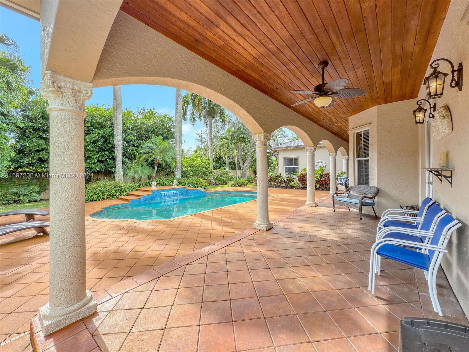 9750 Southwest 143rd Street Miami, FL 33176 - Photo 7 of 41 a view of a porch with furniture and garden
