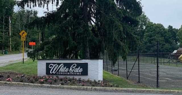 10 White Gate Road, Unit J Wappingers Falls, NY 12590 - Photo 2 of 11 a sign that is sitting on the side of the road