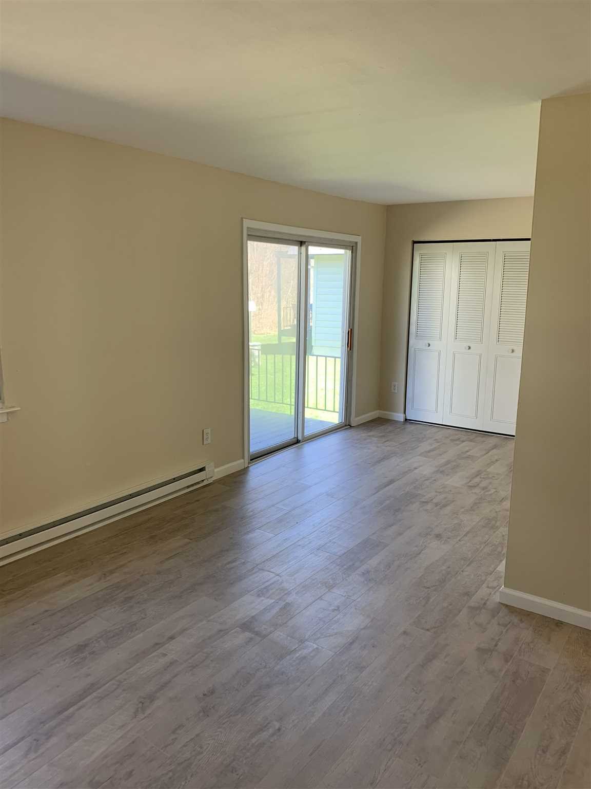 10 White Gate Road, Unit J Wappingers Falls, NY 12590 - Photo 6 of 11 a view of an empty room with wooden floor and window