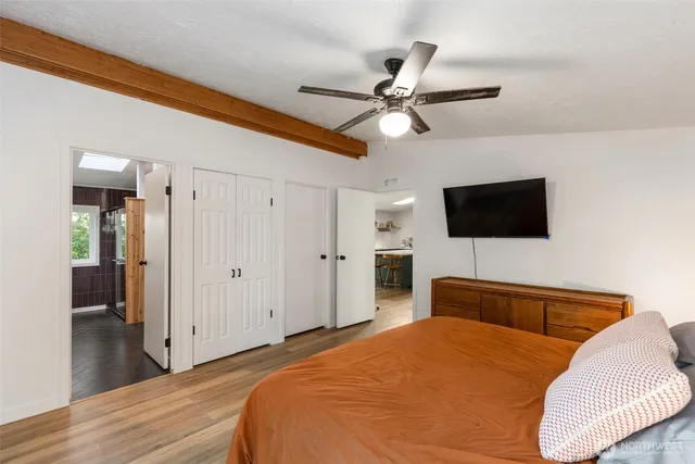 a bedroom with a bed and a flat screen tv