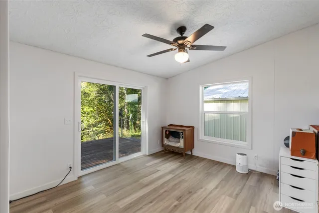 a view of a livingroom with wooden floor and a window
