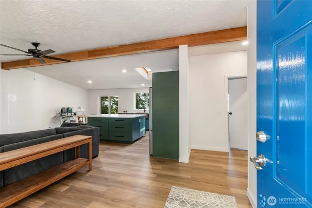 a view of a hallway view with furniture and wooden floor