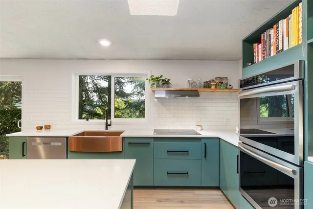 a kitchen with a sink and a stove top oven