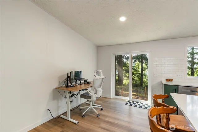 a view of a workspace with furniture and a window