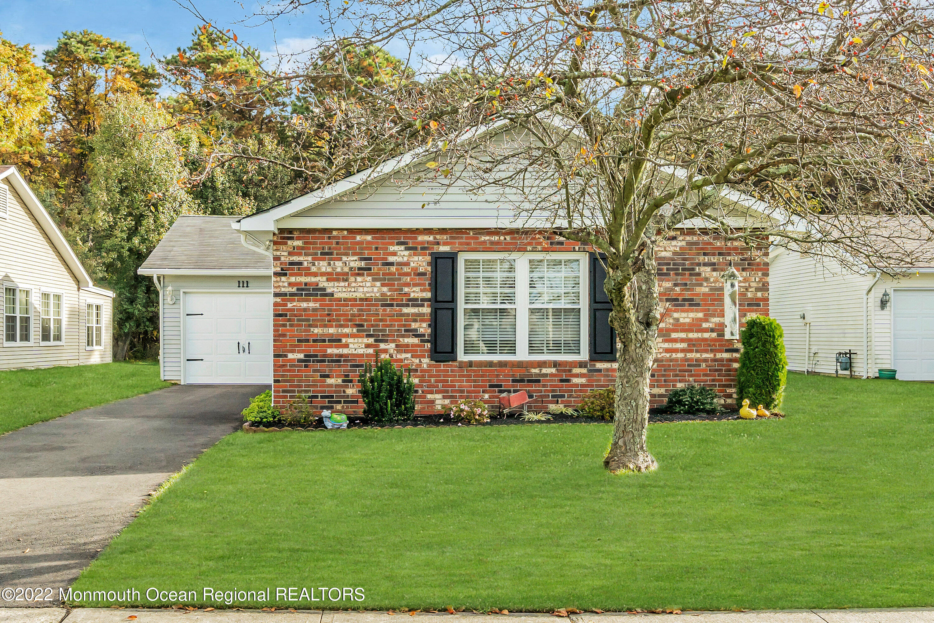 111 Mansfield Drive Brick, NJ 08724 - Photo 1 of 43 a front view of a house with a yard and trees