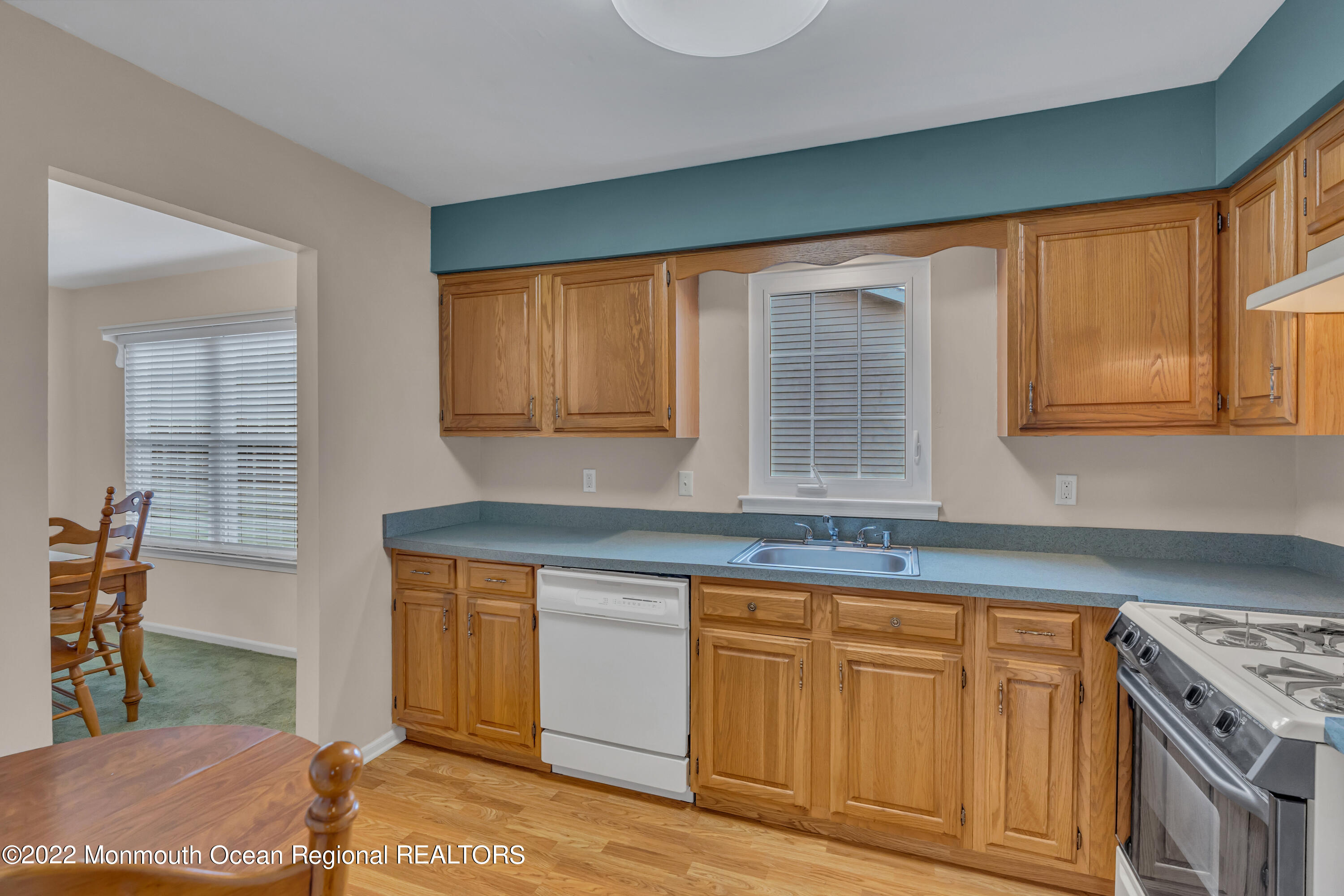 111 Mansfield Drive Brick, NJ 08724 - Photo 15 of 43 a kitchen with granite countertop a sink cabinets and wooden floor