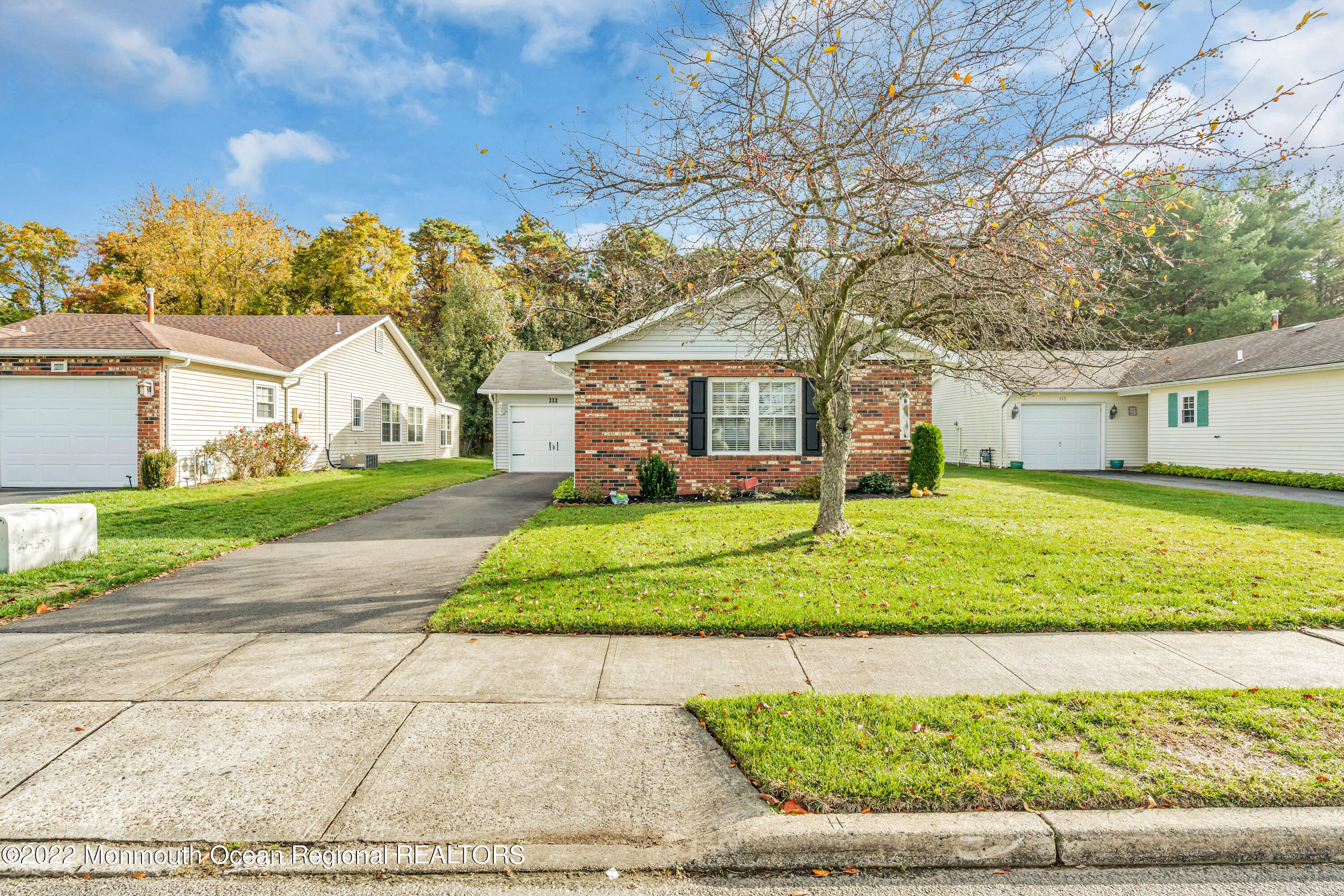 111 Mansfield Drive Brick, NJ 08724 - Photo 34 of 43 a front view of a house with a yard and trees