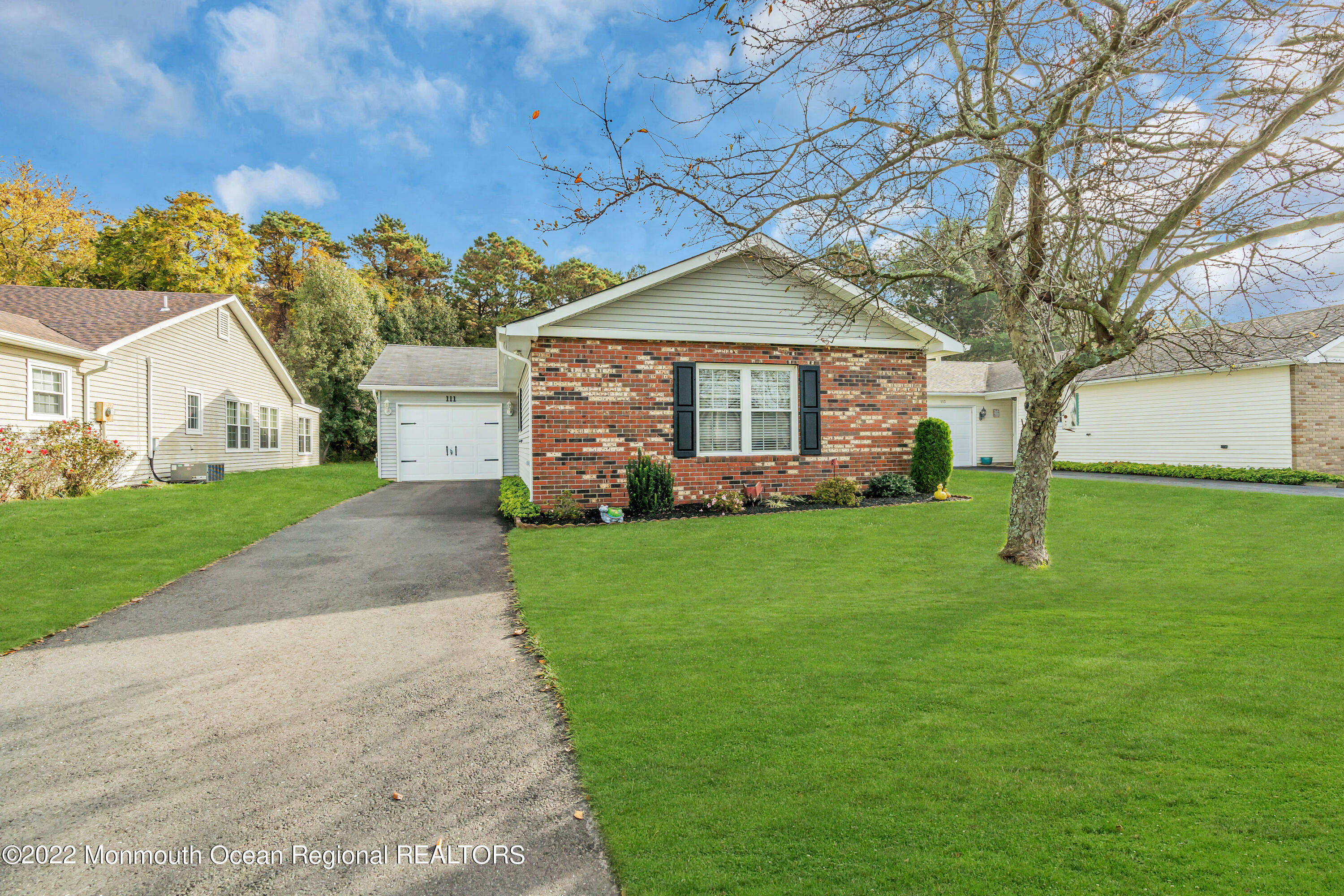 111 Mansfield Drive Brick, NJ 08724 - Photo 41 of 43 a front view of a house with a garden and trees