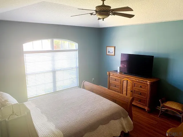 a view of walk in closet with window and white walls